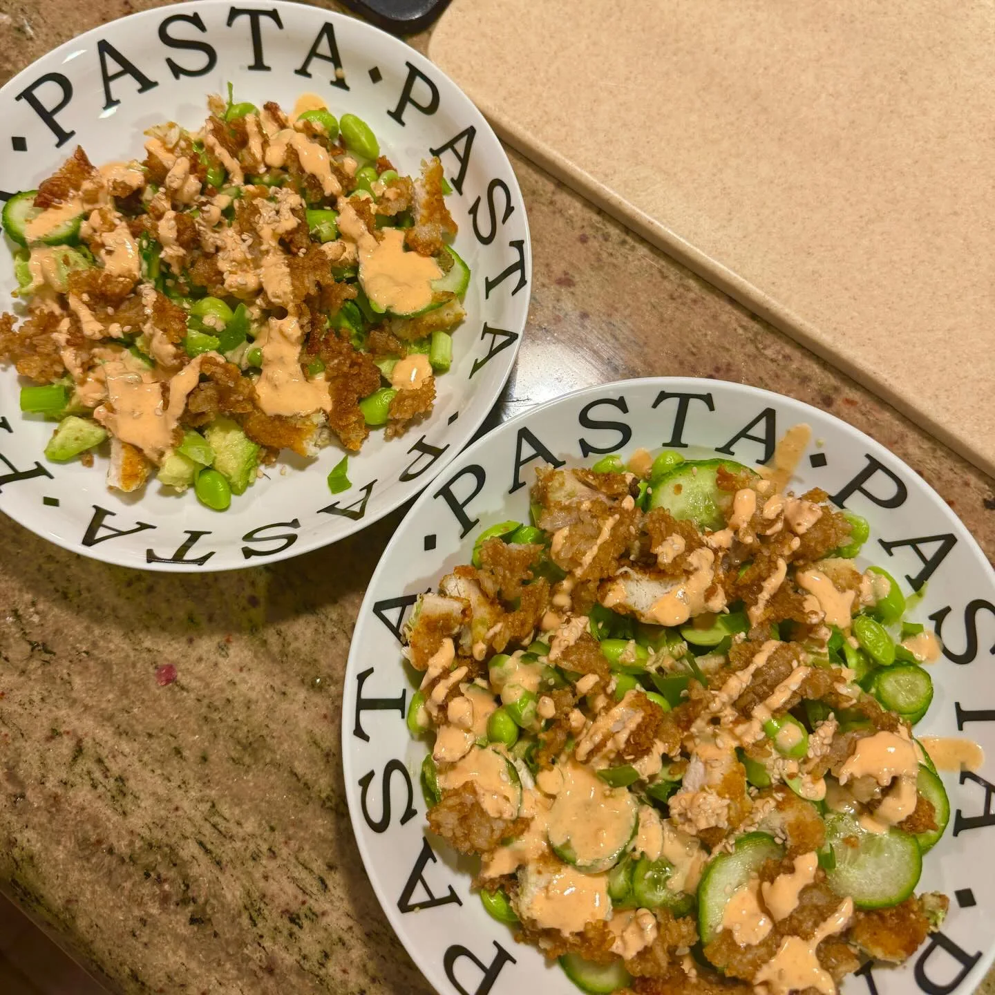 Nothing beats a homemade dinner bowl loaded with crispy chicken and drizzled spicy sauce.